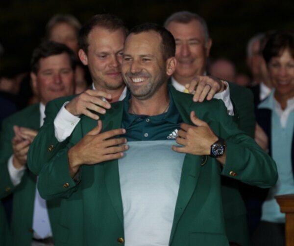 Danny Willett puts the Green Jacket on Sergio Garcia